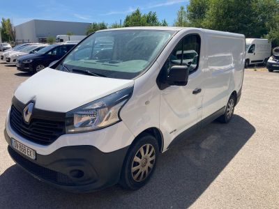 a white van parked in a parking lot with other cars in the background