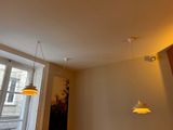 two lights hanging from the ceiling in a room