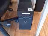 a computer tower sitting on the floor next to a chair