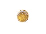 a close up of a gold coin on a white surface