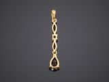 a yellow gold pendant with a black diamond