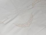 a white bed with a white comforter and a white comforter
