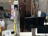 a picture of a refrigerator with a television on top of it