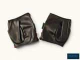 two pairs of black leather gloves sitting on top of each other