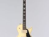 an electric guitar hanging from a string on a wall