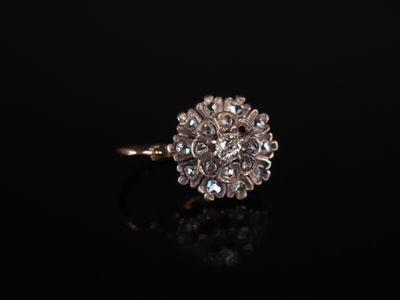 a close up of a diamond ring on a black surface