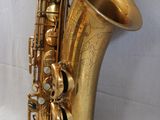 an image of a gold saxophone sitting on top of a white surface