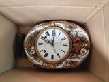 a clock that is sitting in a box on the floor