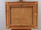 an old wooden easel with a painting on top of it