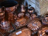 many different types of silverware on display on a table
