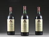 three bottles of wine are lined up on a table