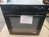a black oven sitting on a table with a price tag on it