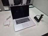 a laptop computer sitting on a desk with a charger