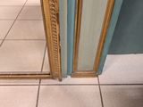 a mirror on the floor in a bathroom with a tiled floor