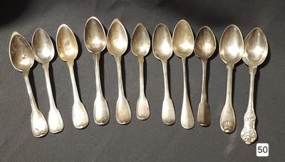 six silver spoons are lined up in a row on a table