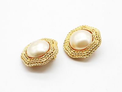a pair of gold and pearl earrings on a white background