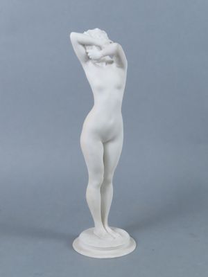 a white statue of a woman with her hands on her head