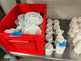 many cups and saucers sitting on a table