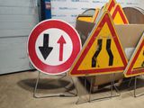 three road signs that are sitting next to each other
