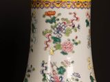 a vase that is sitting on a table with a black background