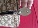 a person holding a purse with a zipper on it