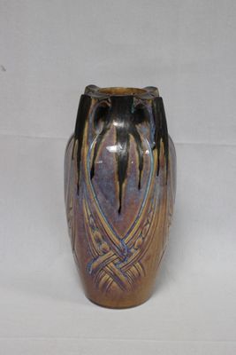 a vase that is sitting on a white surface