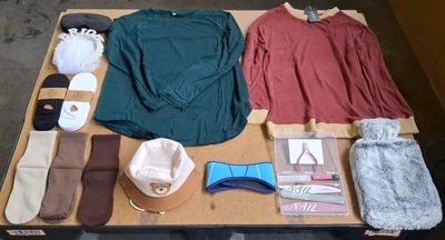 a table with a lot of clothing and accessories on it