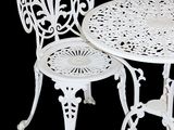 a white table and two chairs sitting next to each other