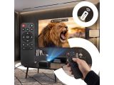 a person holding a remote control in front of a tv