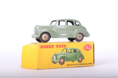 a green toy car sitting on top of a yellow box