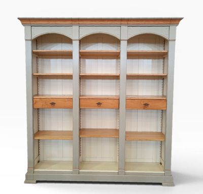 a wooden bookcase with two drawers and two shelves on each side