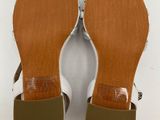 a pair of women ' s white sandals on a white background