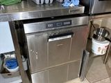 a stainless steel dishwasher in the middle of a kitchen