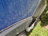a close up of a car ' s front bumper with a hole in it