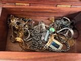 a wooden box filled with lots of different types of jewelry
