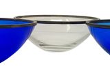 three blue and clear glass bowls sitting next to each other