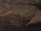a picture of a wood carving of a bird on a piece of wood