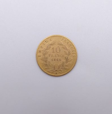 an image of a gold coin on a white surface with a white background