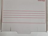 a white box with a red line on it sitting on top of a table