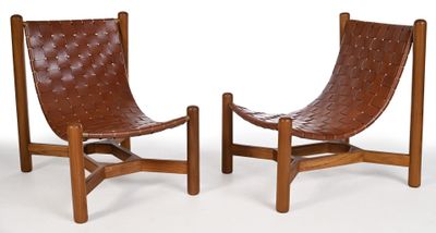 pair of leather lounge chairs with wooden frame and leather seat