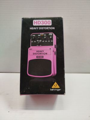 the box of a pink guitar effects pedal sits on a white surface