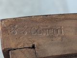a close up of a piece of wood with writing on it