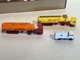 three toy trains sitting next to each other on a table