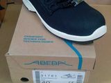 men ' s shoes in a box on a table with a cardboard box