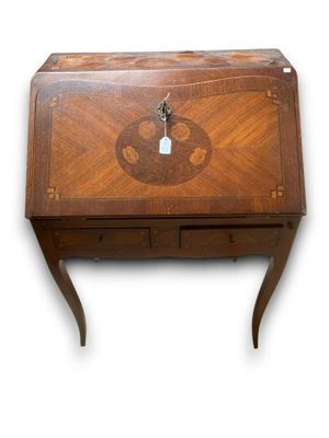 a small wooden desk with a clock on top of it
