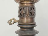 a metal lamp that is sitting on a table