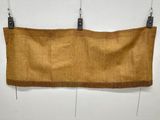 a brown bag hanging on a wall with two black hooks