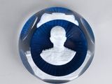 a glass sculpture of a woman in a blue circle