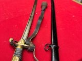 pair of swords on a red table cloth with a chair in the background