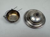 two silverware items are sitting on a white surface